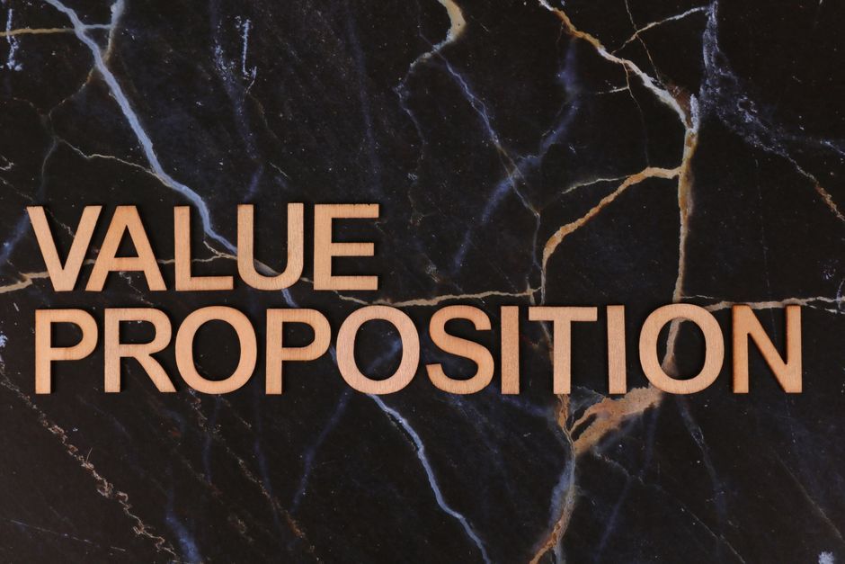 Wooden letters spelling 'Value Proposition' on a marble background, symbolizing business strategy.