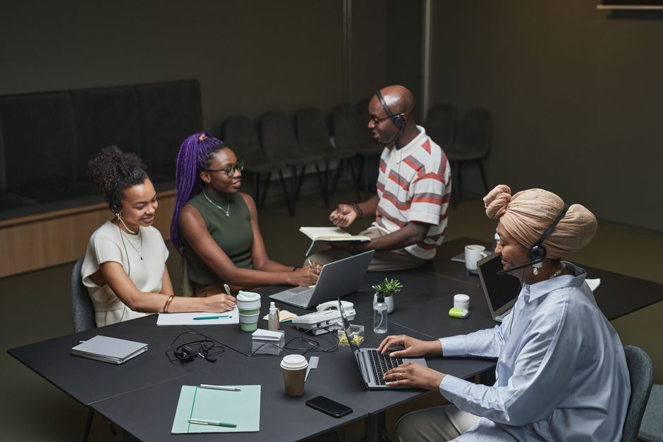 A diverse team works together in a modern office, showcasing collaboration and teamwork.