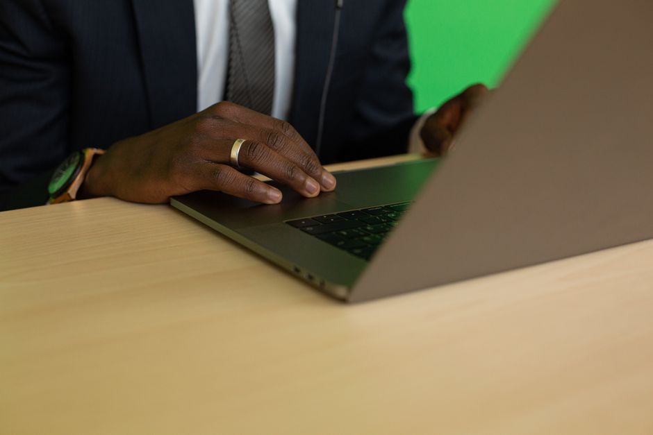 Close-up of a professional working on a laptop at a desk, suitable for business themes.