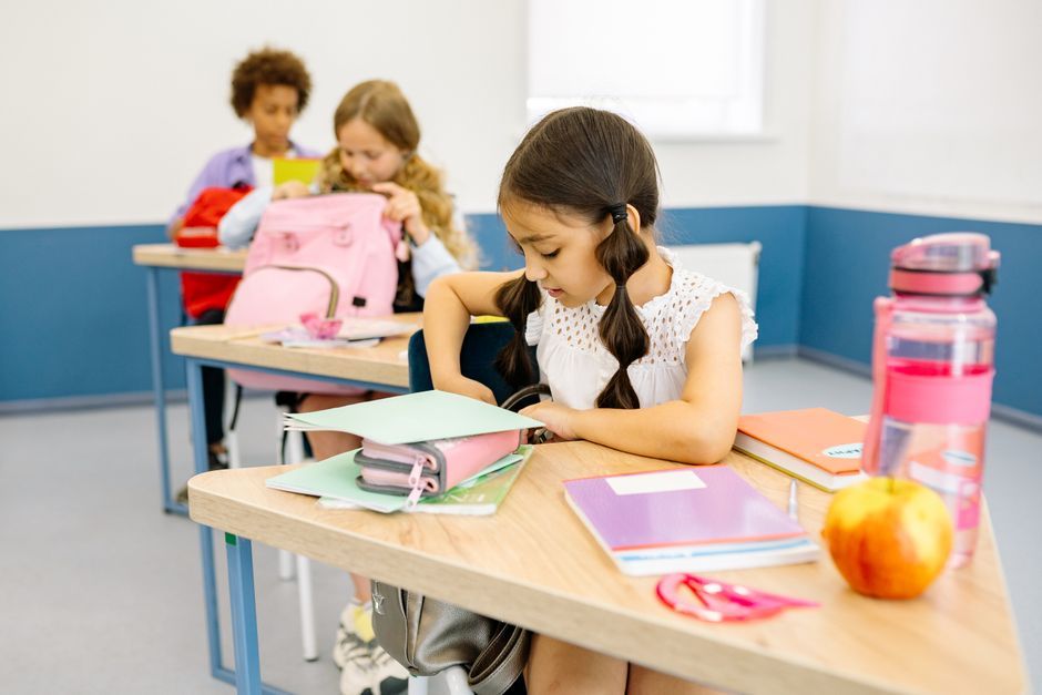 Diverse children participating actively in a colorful school classroom setting.