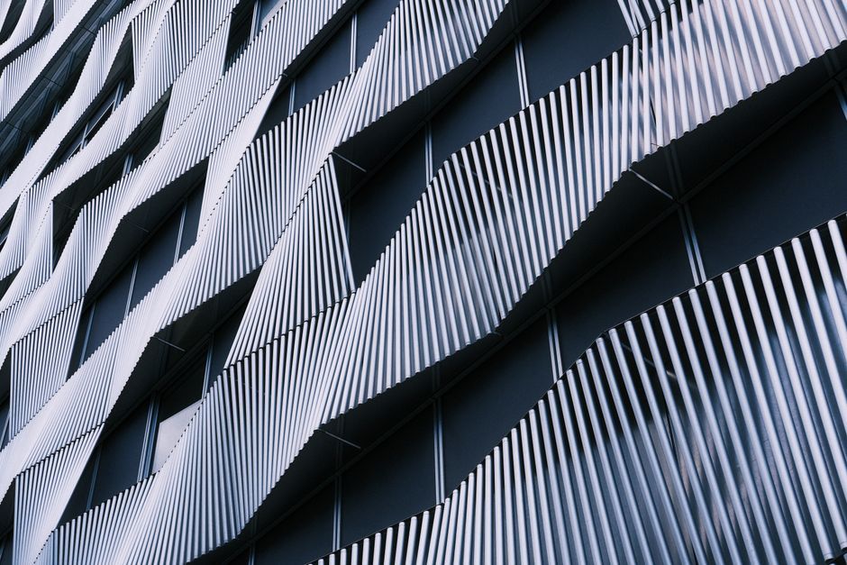 Architectural facade featuring a modern, wavy metal pattern. Unique and contemporary exterior design.