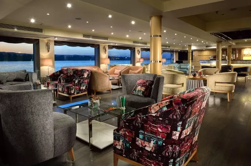 Luxurious cabin aboard MS Acamar Nile Cruise – plush bedding and panoramic window with Nile views