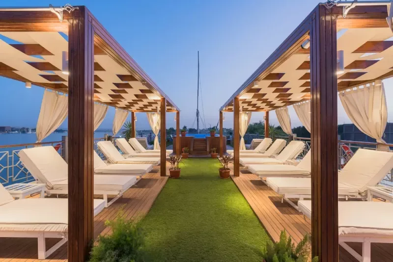 Relaxed guest enjoying leisure on Dahabiya deck Egypt luxury travel