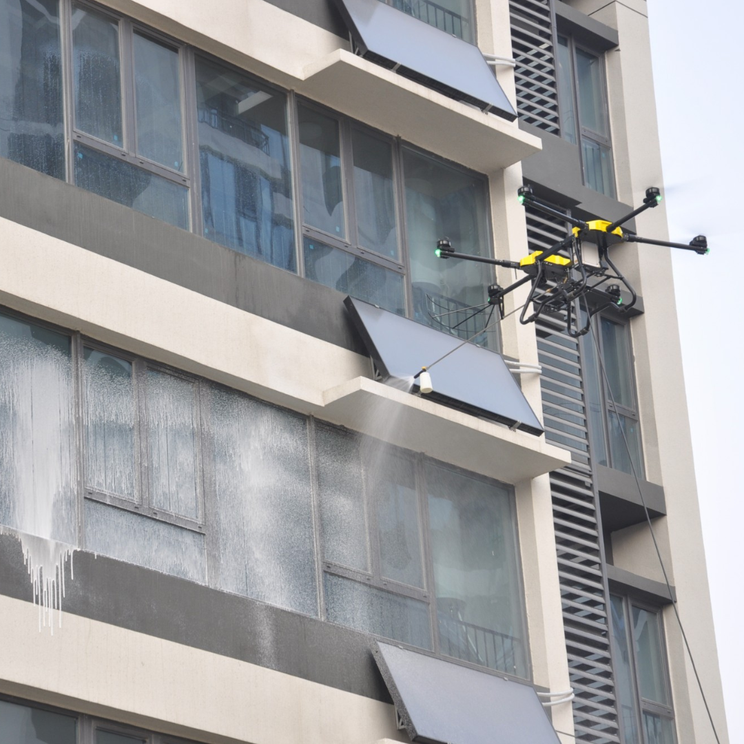 Drone cleaning windows on a high-rise building