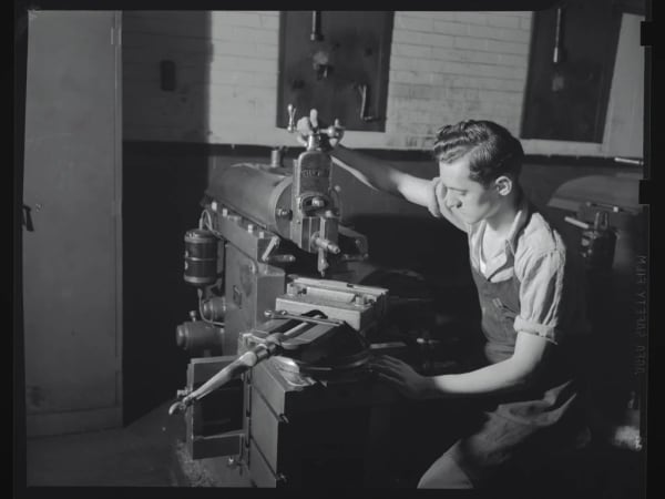 A boy using a machine at Dunbar School (Glasgow School)