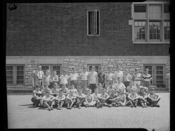 Bryan Hill School: Group Photo of Boys Baseball Team Sitting and Standing in Three Rows Outside