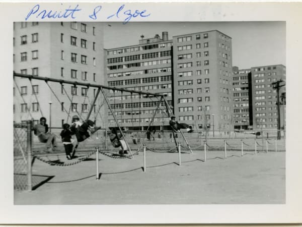 Children playing on Pruitt-Igoe housing project playground swings