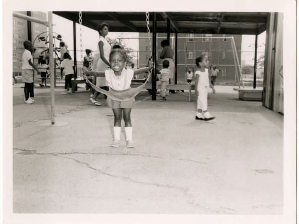 Unidentified girl on a swing at the Pruitt-Igoe Day Nursery, 2328 Biddle