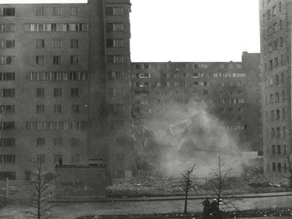 Dust rising from falling rubble during the demolition of a Pruitt-Igoe housing building