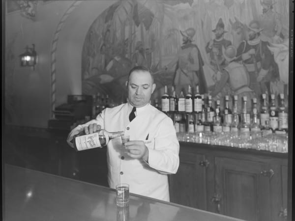 Bartender George J. Paulos Pouring a Shot of Kentucky Tavern Whiskey at the Lennox Hotel Bar, Washington Avenue and North 9th Street