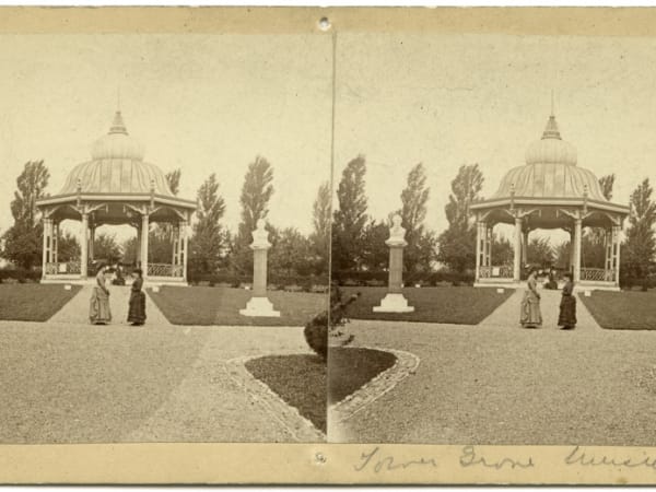 Two women standing in front of the Tower Grove Park music stand.