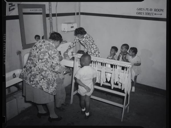 Riddick School: Two Women Helping Six Children Clean