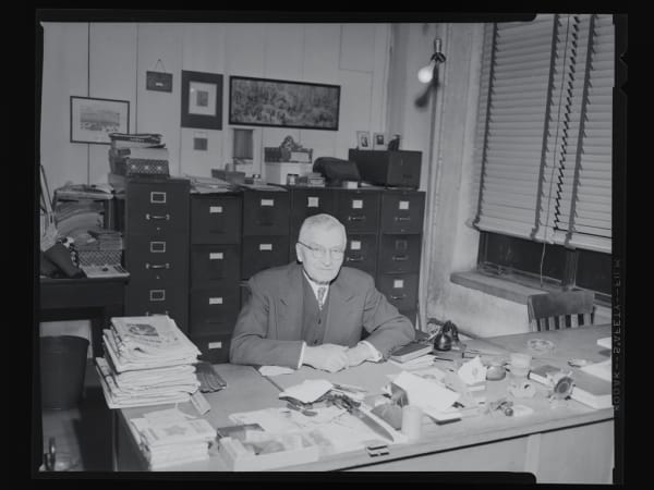 Fashion Square Building: Max Willmann sitting in his office at the Fashion Square Building