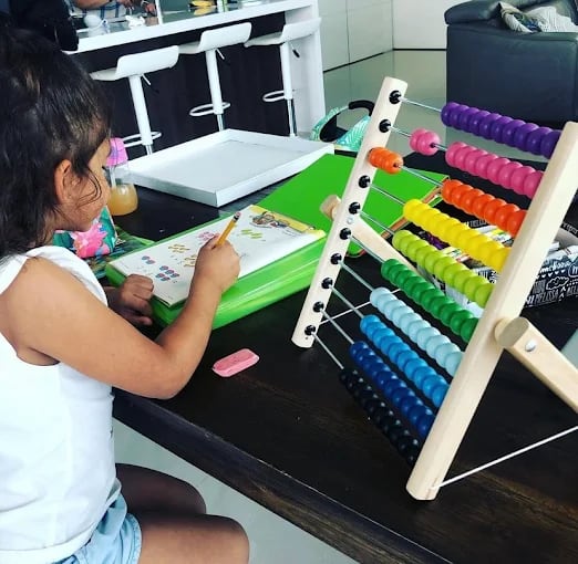Young students working through hands-on math at the Eaton Kendall microschool
