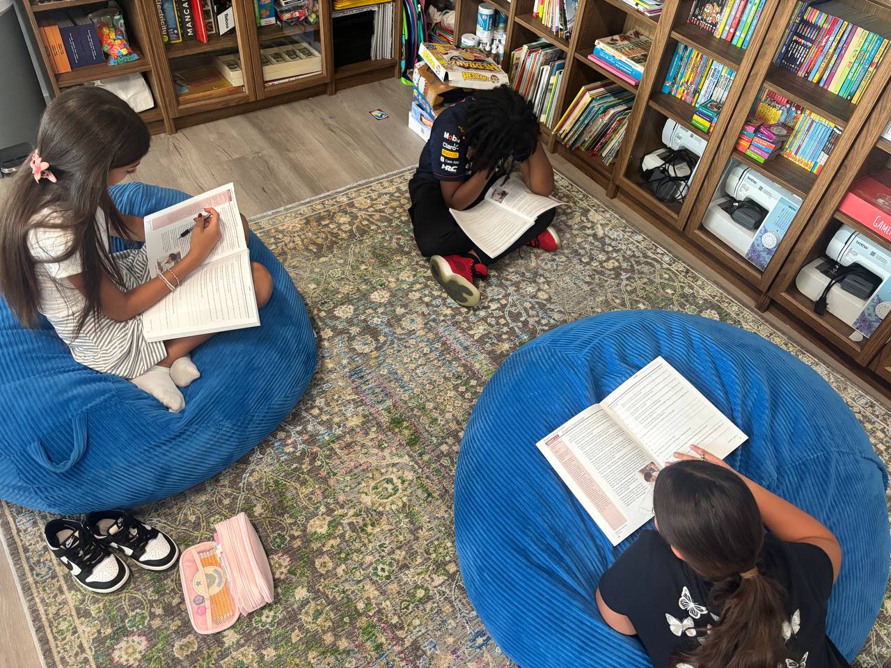 Students reading on bean bags in the library corner of the Eaton Homestead microschool