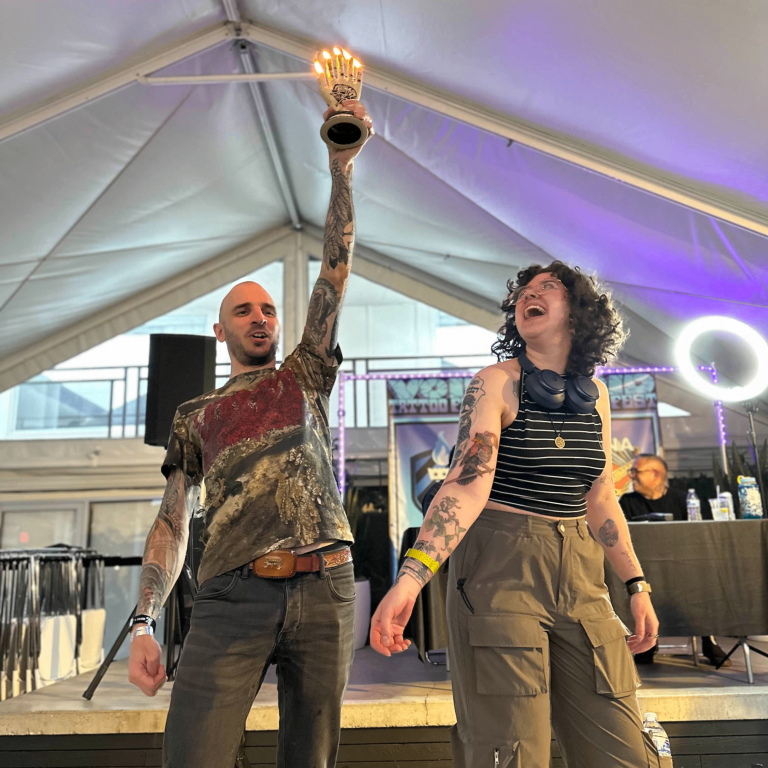 Winner! Tattooer and client being awarded for their tattoo.