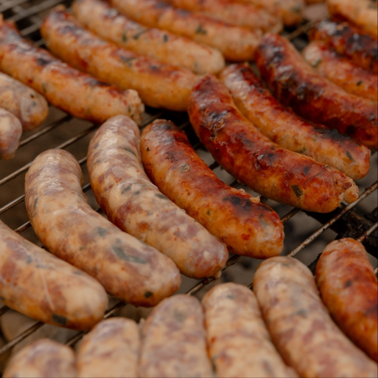 sausages cooking on a grill