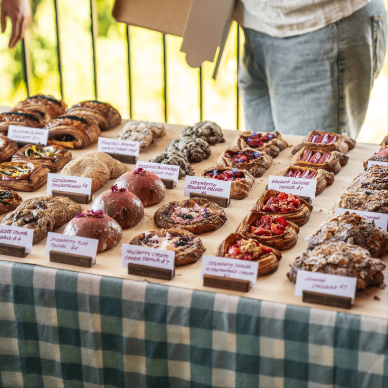baked goods lined up on a table for sale