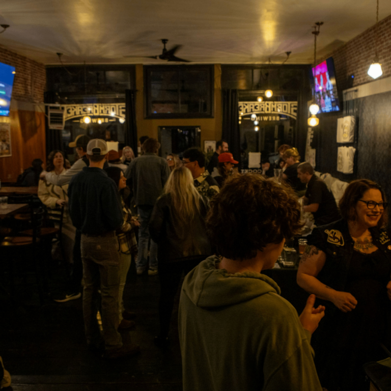 people mingling inside a bar