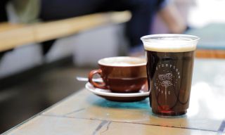 two cups of coffee sit on a table