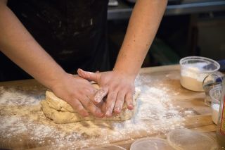 hands kneading biscuit dough