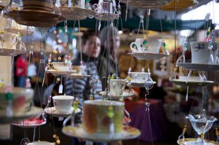 hanging teacups and saucers on display for sale