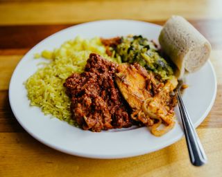 A plate full of food served by Horn of Africa restaurant.
