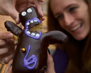 a humanoid-shaped donut being split in two