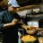 Akadi\'s Chef Fatou Ouattara prepares a bowl of mafe (peanut butter stew).