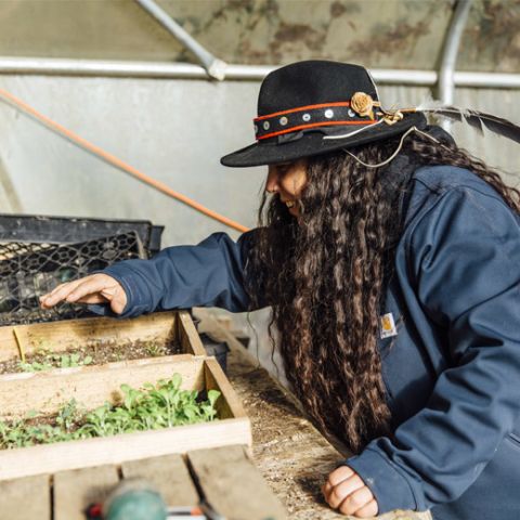 Valenzuela tends to plants at Tryon Life Community Farm.
Photo credit: Ashley Anderson