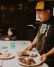 Chef Carlo Lamagna reviews dishes with his child at a Magna pop-up.