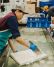An Ota Tofu employee hand-cuts tofu into blocks.