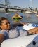 Dametris Harrison floats alongside swimmers near Waterfront Park.