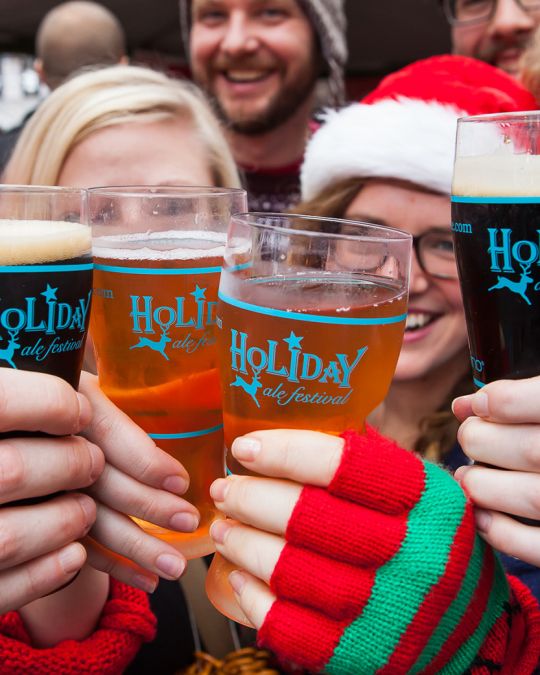 Give cheers for beers underneath the Holiday Ale Festival\'s clear tent.