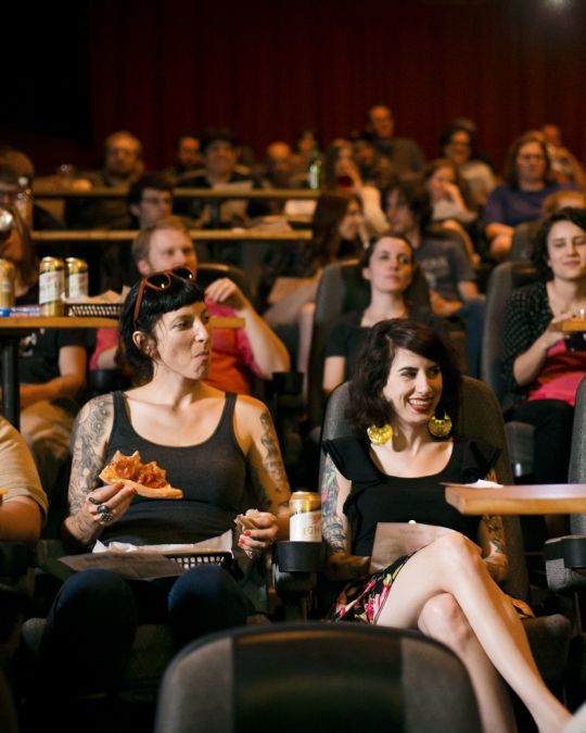 Film fans enjoy beer and pizza with a movie at the Hollywood Theatre.