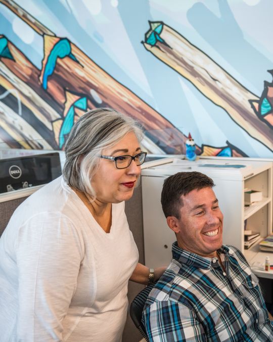 Travel Portland\'s modern, open office includes lots of natural light and features like murals by local artists.
