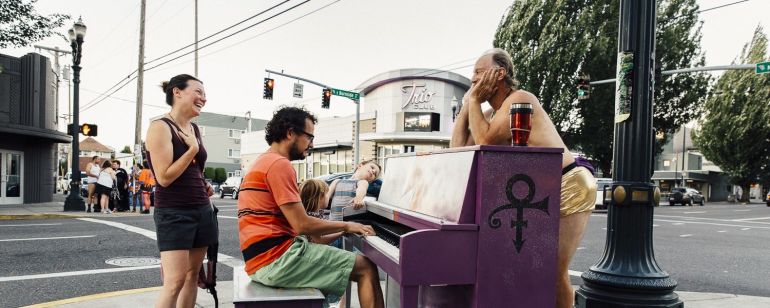Passerby enjoy an impromptu Piano Push Play concert on the East Burnside instrument.