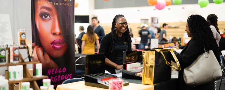 An attendee at My People\'s Market visits the Hue Noir booth.