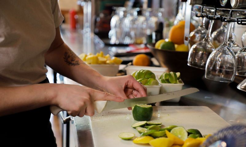 A bartender prepares citrus fruits for cocktails at Miss Delta on North Mississippi Avenue.