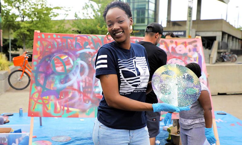 Local artists and visitors collaborating on making art on the spot at My People's Market in 2018.