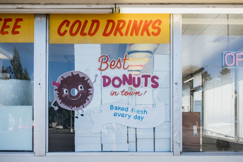 Painted window sign at a donut shop