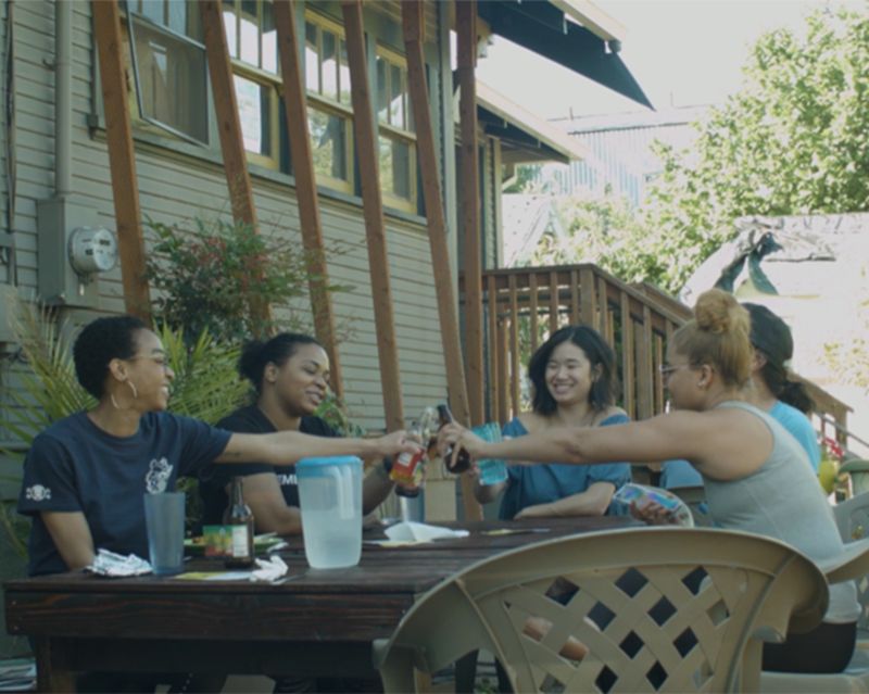 Crissle and her local hosts share a toast at Jamaica House in North Portland.