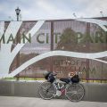 a bicycle leaning against a sign that says \"City of Gresham\"