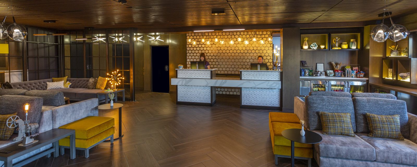 Two receptionists ready to greet guests in the modern lobby of the Silver Cloud Portland.