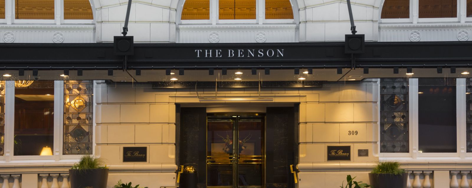 The entrance of The Benson Portland features a large stone archway.