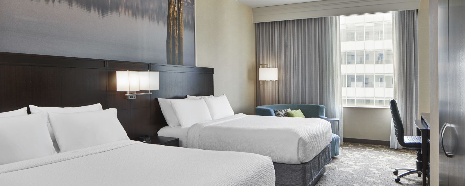 The modern chic Queen Guestroom at the Courtyard by Marriott Portland City Center.