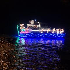 Two boats adorned with Christmas lights