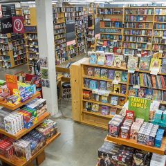 a large room filled with bookshelves and display tables covered with books