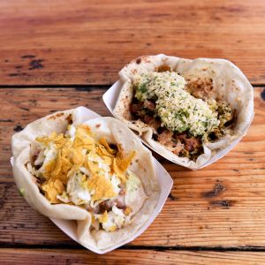 two tacos on a wooden table