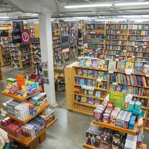 a large room filled with bookshelves and display tables covered with books